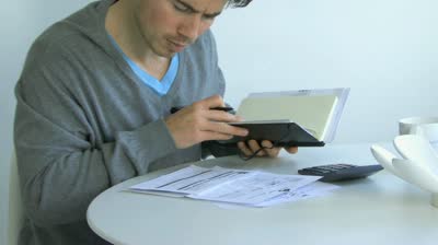 stock-footage-medium-shot-pan-of-a-man-sorting-out-finances